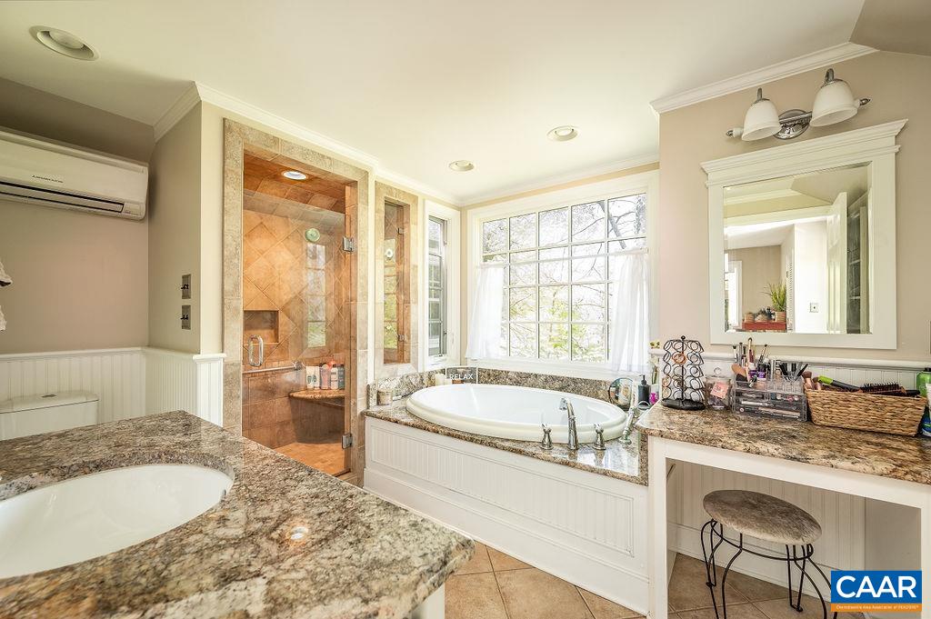 19 Old Farm Road Charlottesville, VA 22903 - Photo 17 of 29 a spacious bathroom with a granite countertop tub sink and mirror