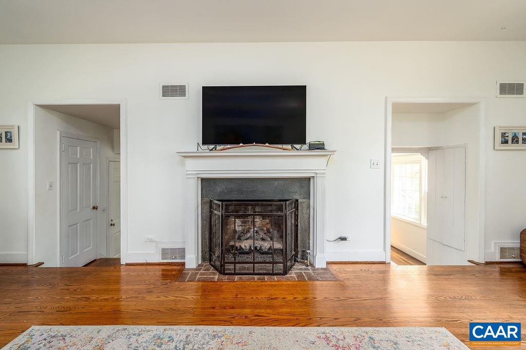 19 Old Farm Road Charlottesville, VA 22903 - Photo 7 of 29 a living room with a fireplace and a flat screen tv