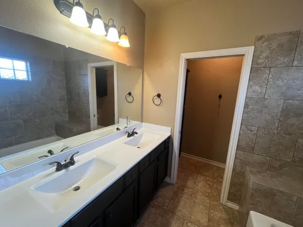 a bathroom with a double vanity sink a and mirror