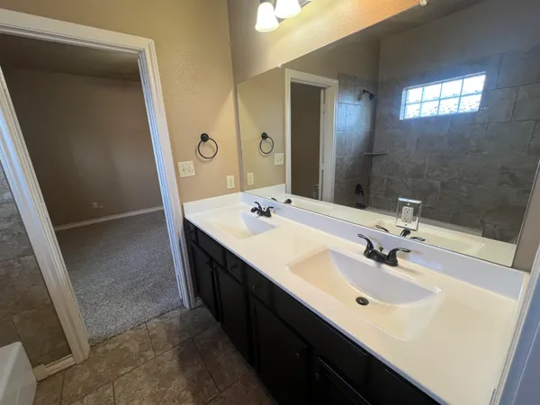 a bathroom with a sink a mirror and a bathtub