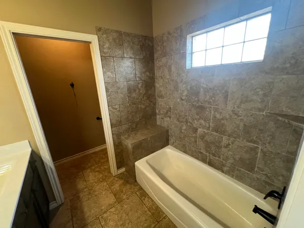 a bathroom with a tub and a shower