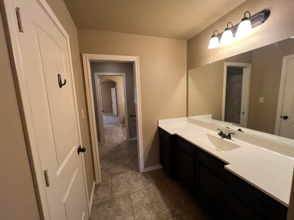 a bathroom with a double vanity sink and mirror