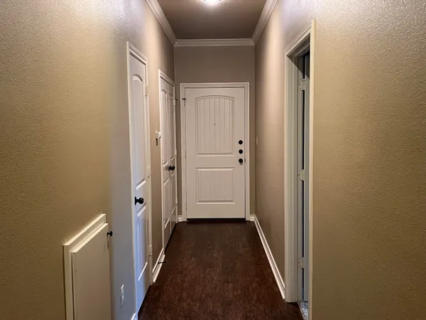 a view of a hallway with a wooden door