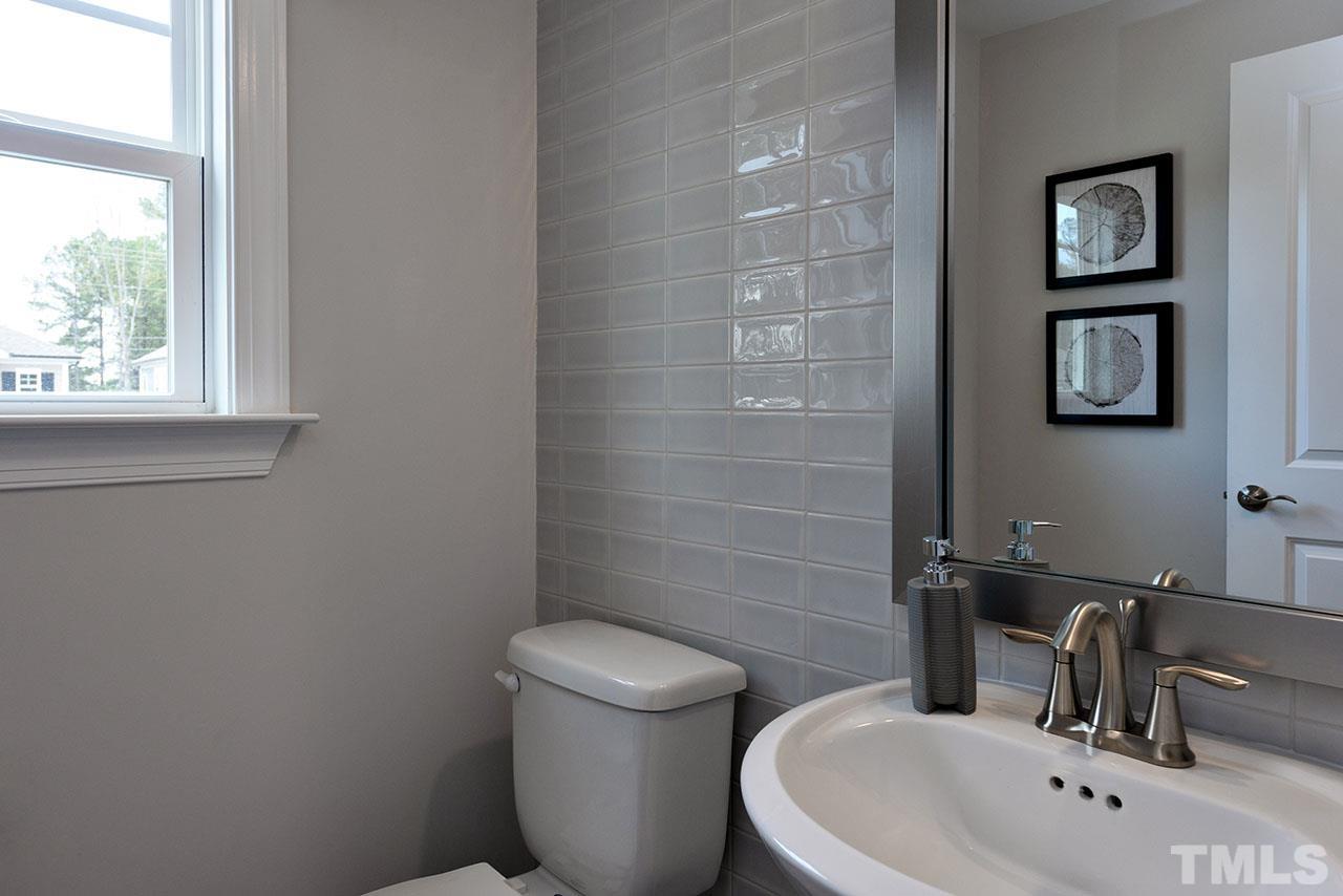 3251 Lynn Road, Unit 17 Raleigh, NC 27613 - Photo 20 of 22 a bathroom with a toilet sink and mirror