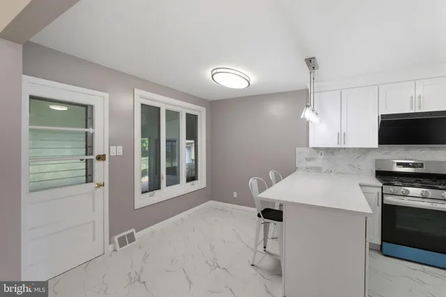 a kitchen with stainless steel appliances and refrigerator