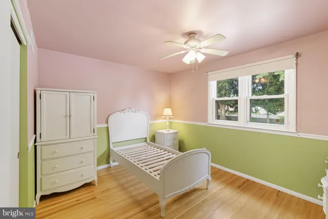 a view of a bedroom with wooden floor
