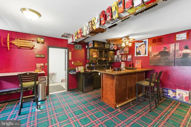 a living room with furniture large windows and wooden floor