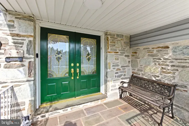 a backyard of a house with outdoor seating and a shower