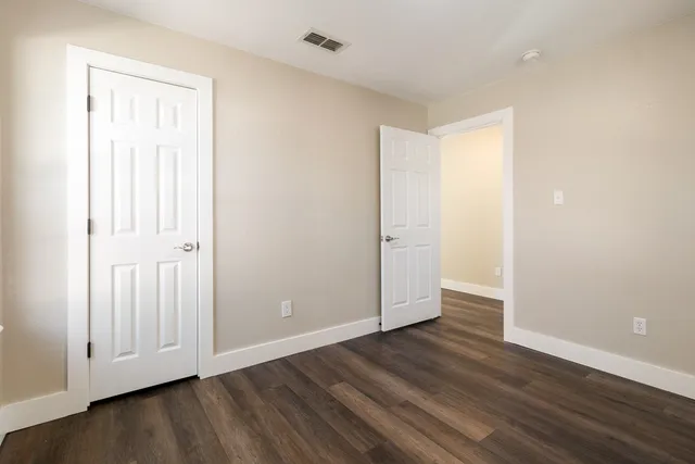 an empty room with wooden floor