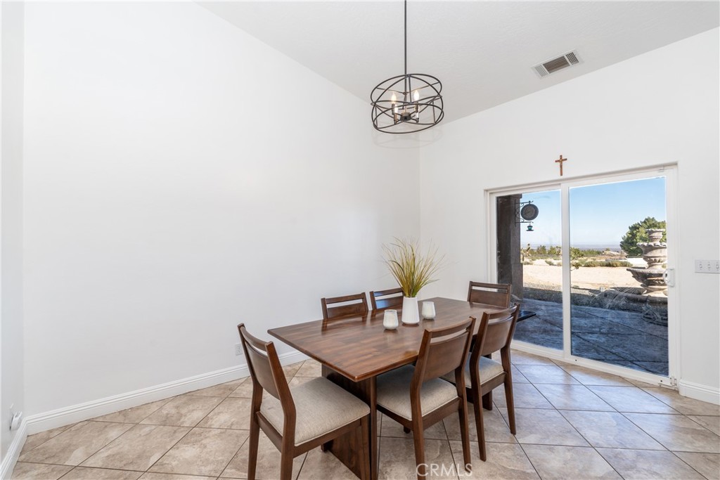 1830 Calaveras Road Pinon Hills, CA 92372 - Photo 14 of 38 a view of a dining room with a table and chairs