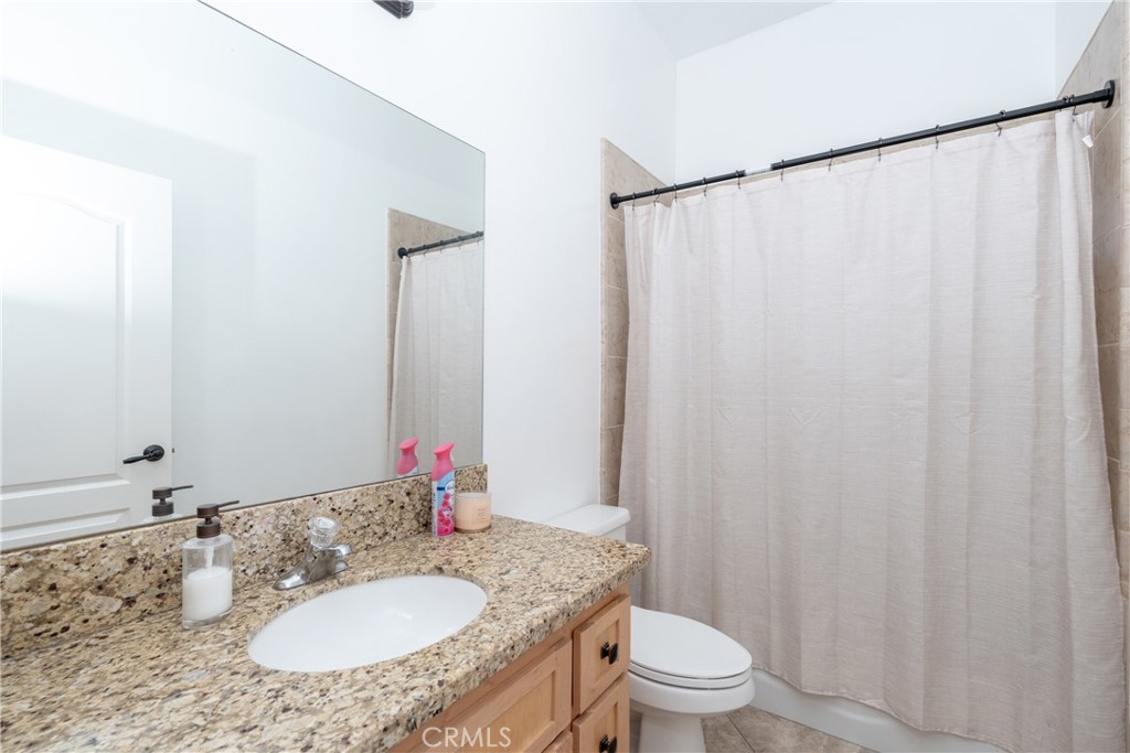 1830 Calaveras Road Pinon Hills, CA 92372 - Photo 19 of 38 a bathroom with a granite countertop sink and a mirror