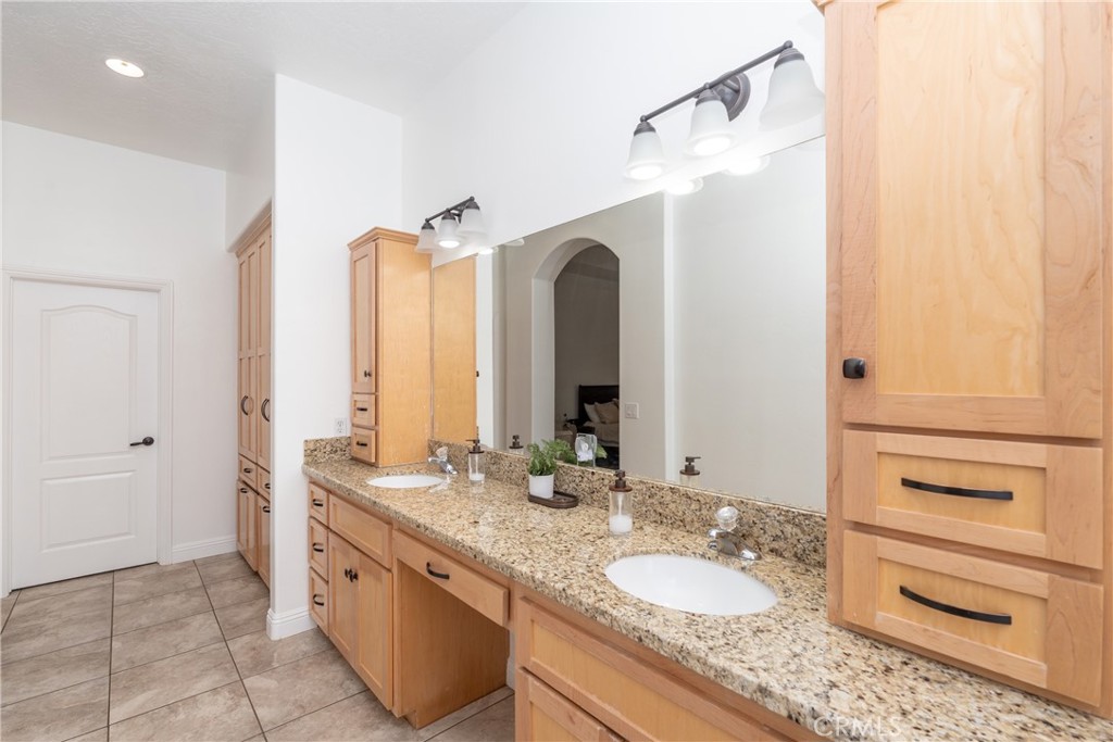 1830 Calaveras Road Pinon Hills, CA 92372 - Photo 21 of 38 a bathroom with a granite countertop sink and a mirror