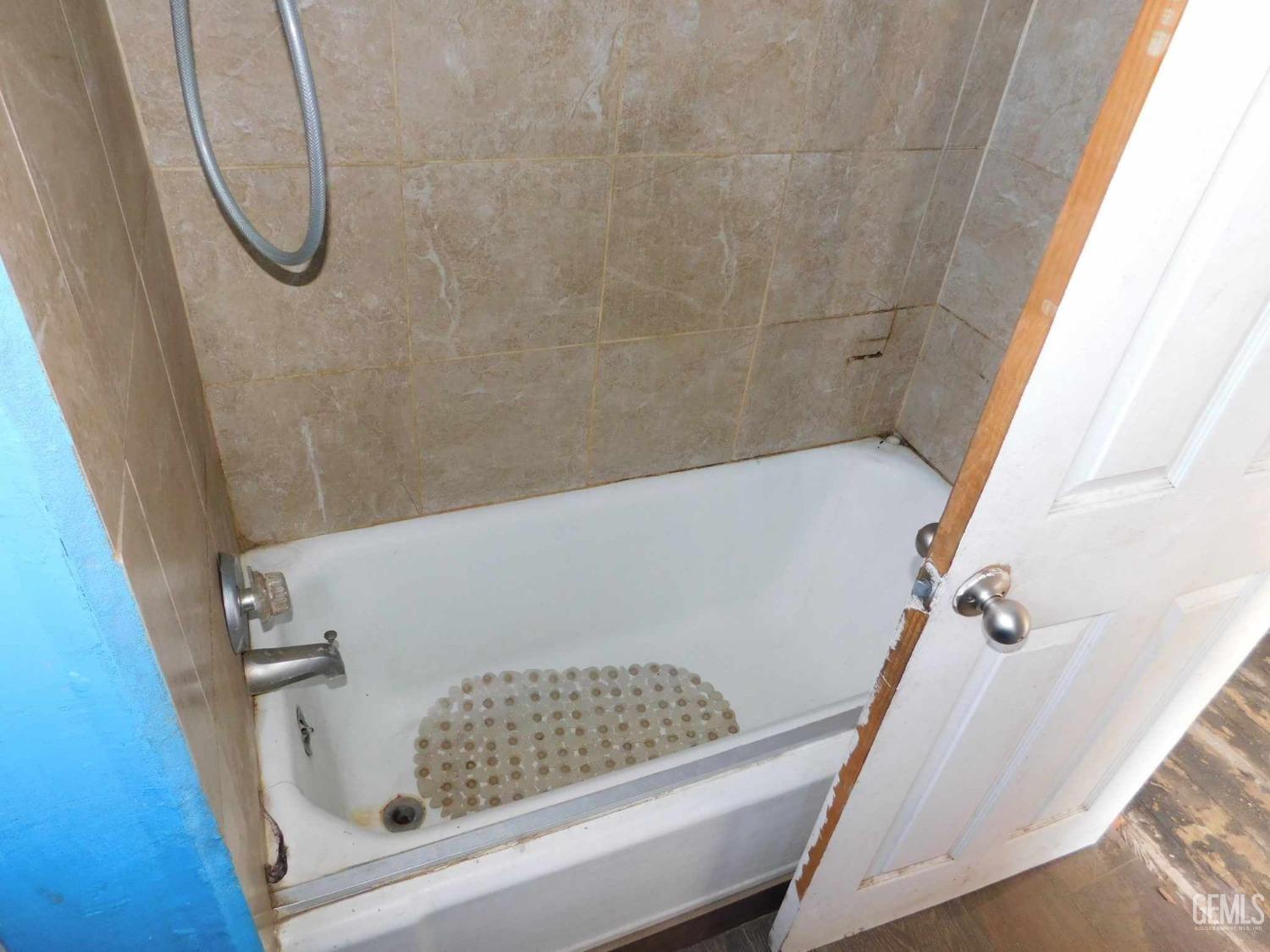 Undisclosed Address Bakersfield, CA 93305 - Photo 11 of 22 a bathroom with a bathtub and a shower