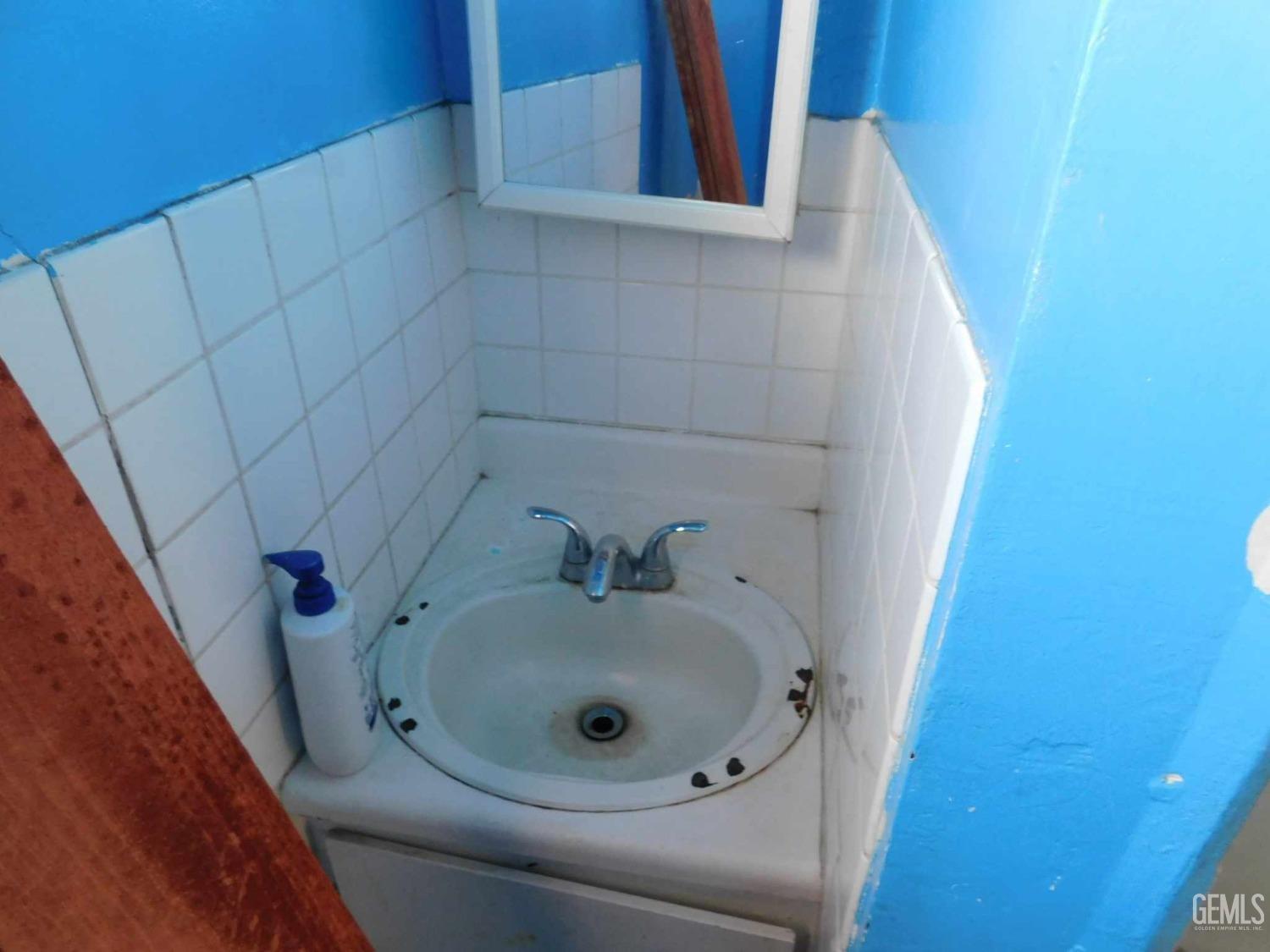 Undisclosed Address Bakersfield, CA 93305 - Photo 12 of 22 a bathroom with a sink and vanity