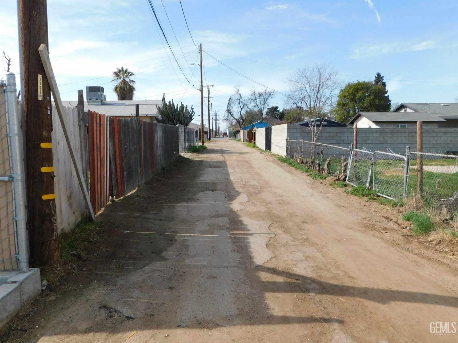 Undisclosed Address Bakersfield, CA 93305 - Photo 18 of 22 a view of a pathway with a wrought fence