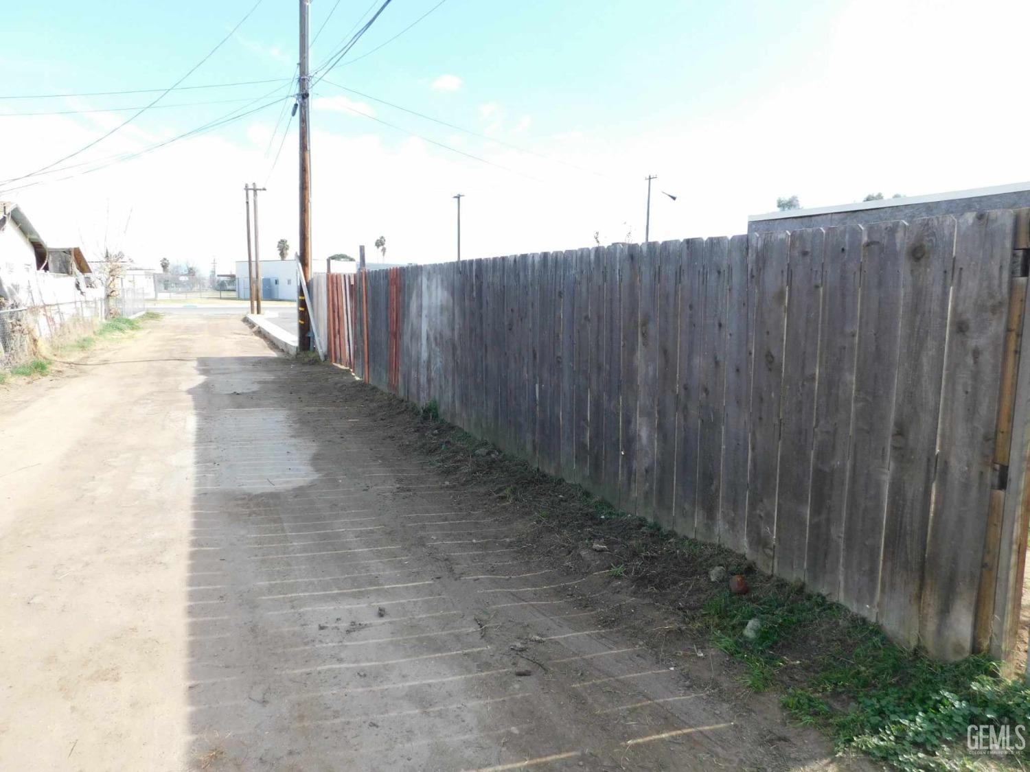 Undisclosed Address Bakersfield, CA 93305 - Photo 20 of 22 a view of a backyard with wooden fence