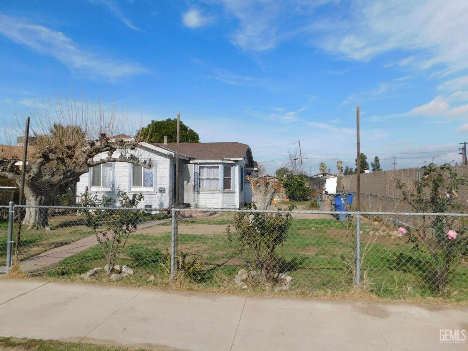 Undisclosed Address Bakersfield, CA 93305 - Photo 2 of 22 a view of a house with a yard and potted plants