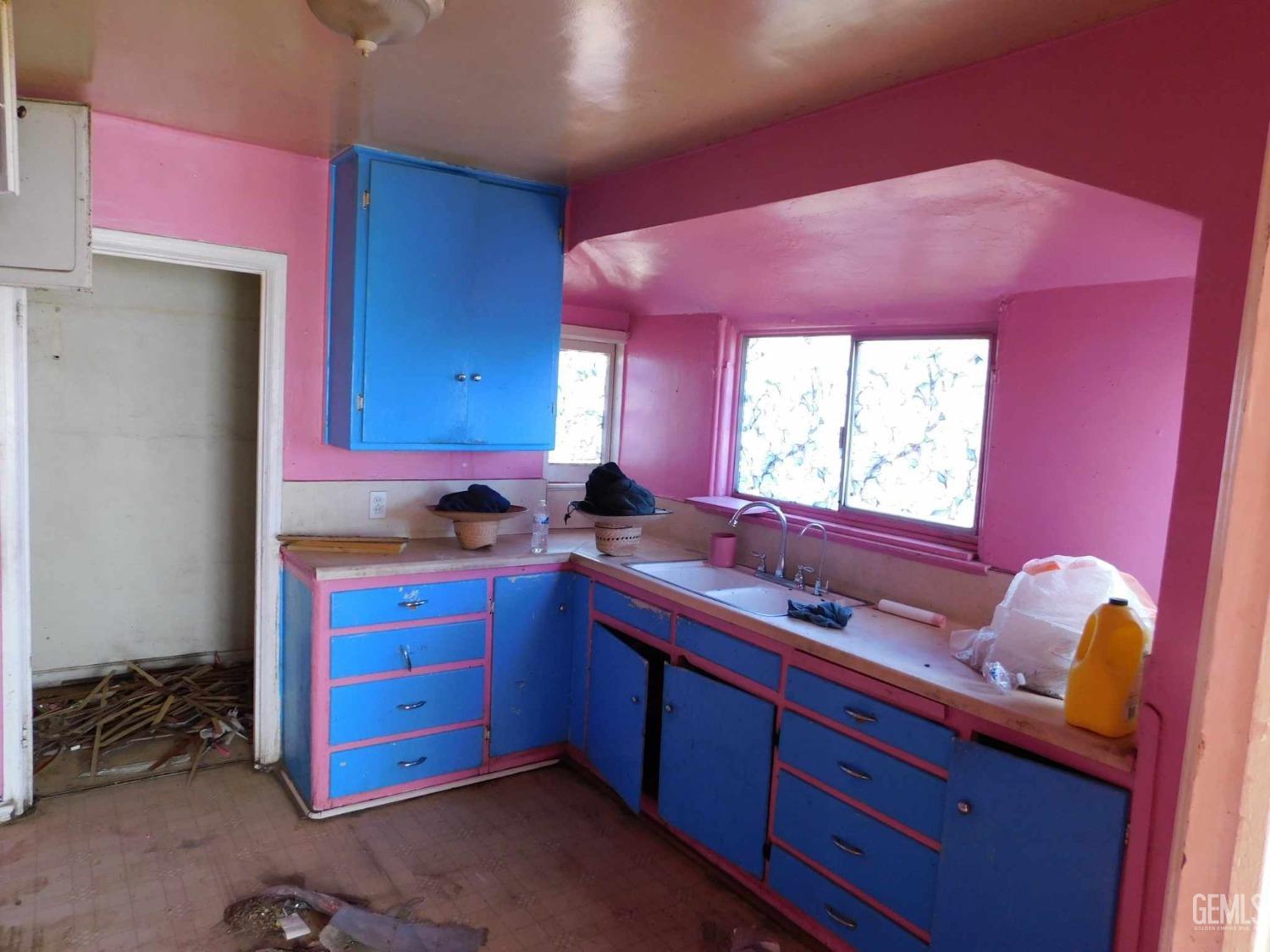 Undisclosed Address Bakersfield, CA 93305 - Photo 8 of 22 a kitchen with granite countertop a sink cabinets and a window