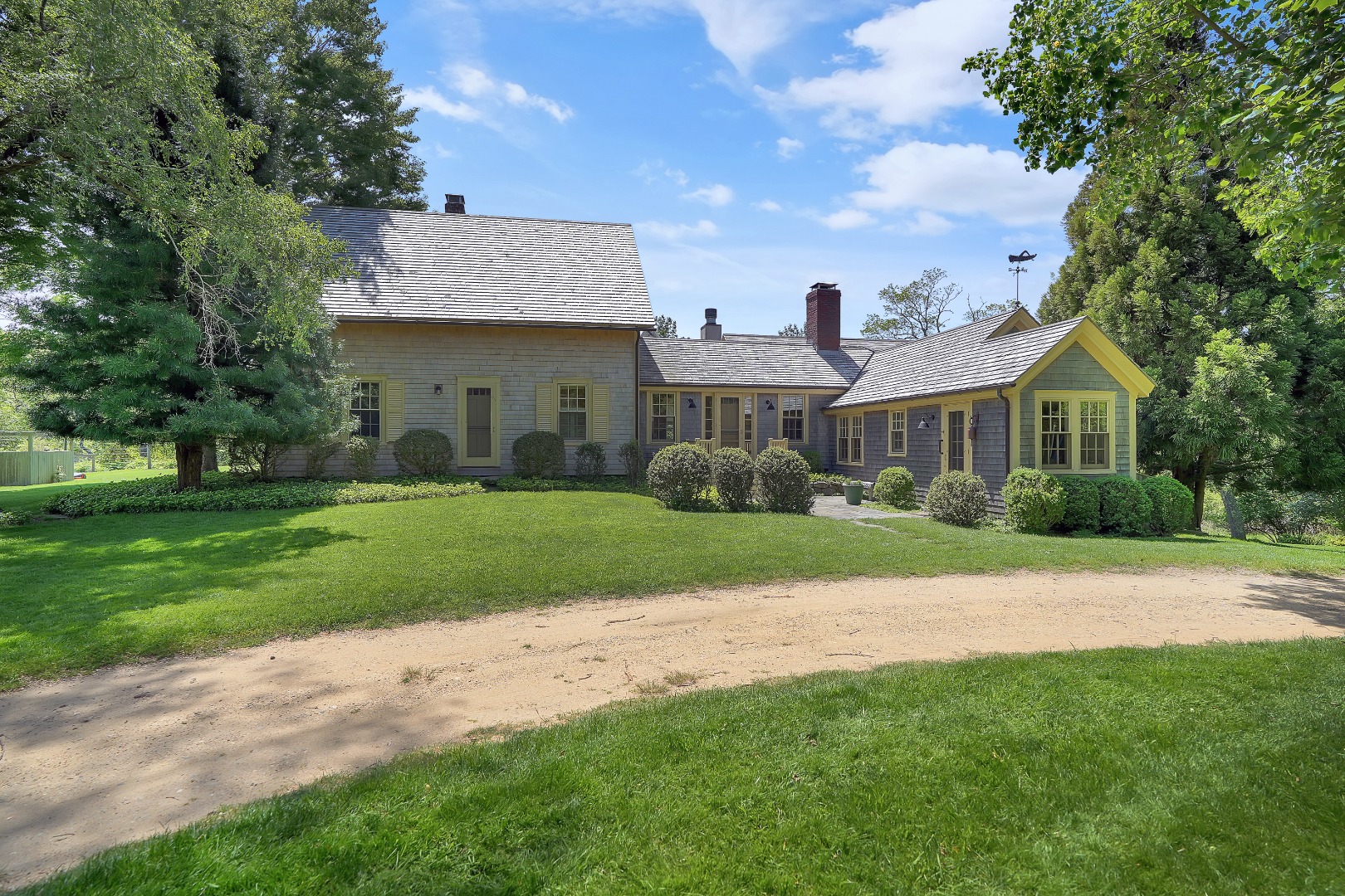 122 Old Farm Road Chilmark, MA 02535 - Photo 3 of 36 a front view of a house with a yard and trees