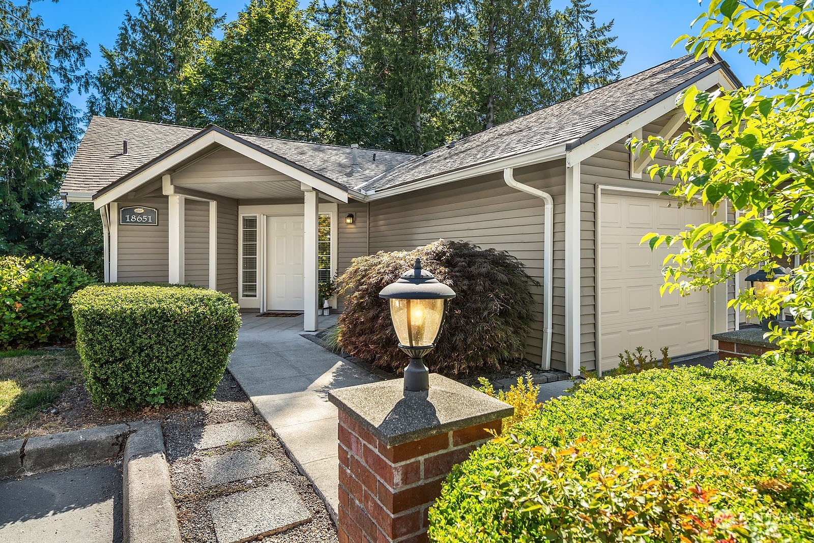 18651 Northeast 55th Way, Unit PP Redmond, WA 98052 - Photo 1 of 35 a front view of a house with garden