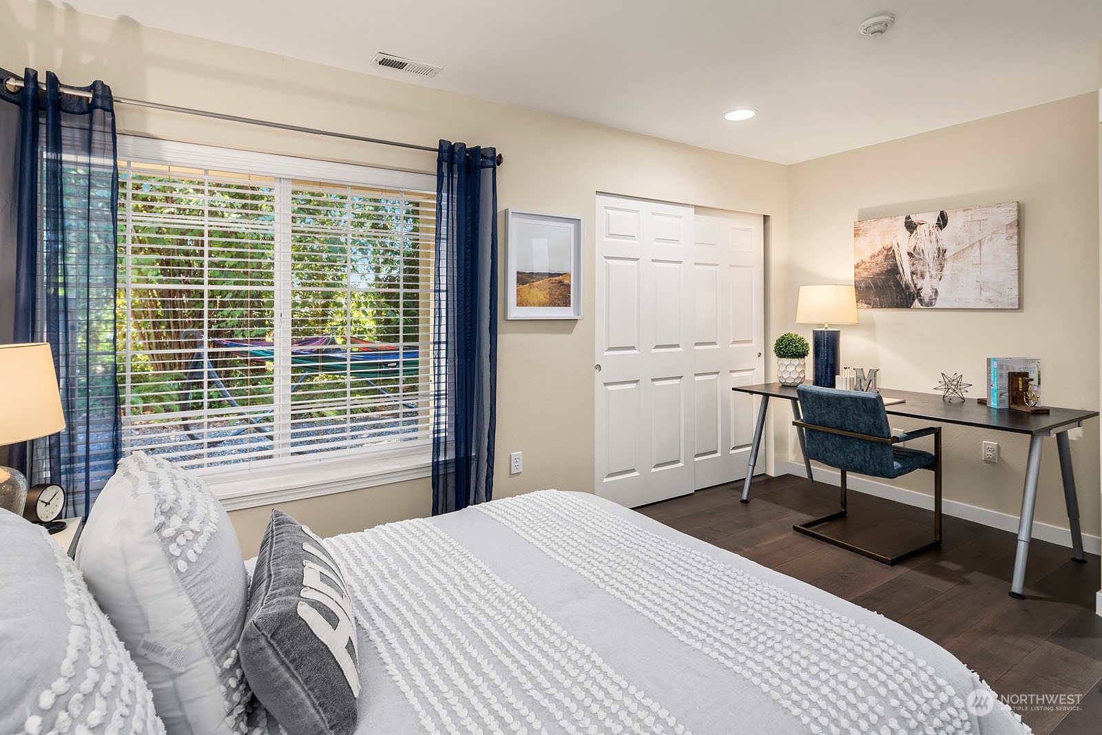 18651 Northeast 55th Way, Unit PP Redmond, WA 98052 - Photo 22 of 35 a bedroom with a bed a table and a large window