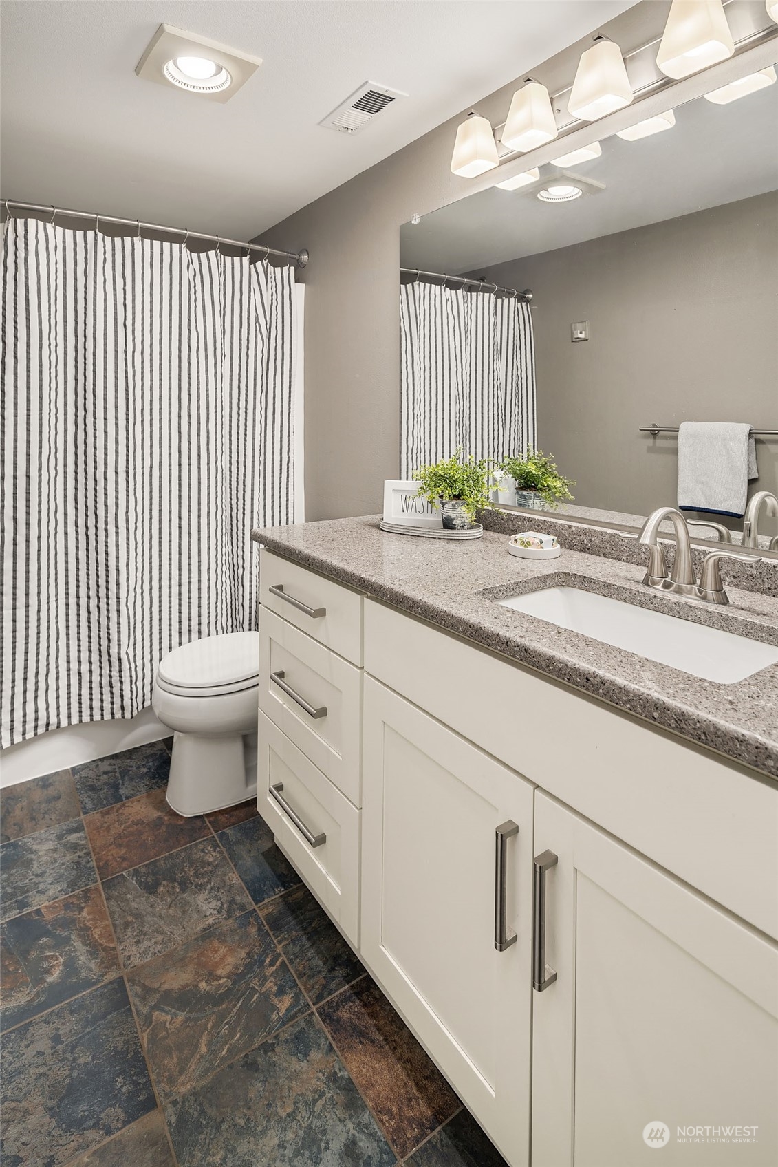 18651 Northeast 55th Way, Unit PP Redmond, WA 98052 - Photo 24 of 35 a bathroom with a sink a toilet and mirror