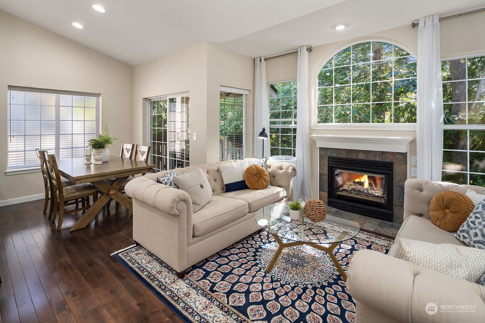 18651 Northeast 55th Way, Unit PP Redmond, WA 98052 - Photo 6 of 35 a living room with furniture a large window and a fireplace