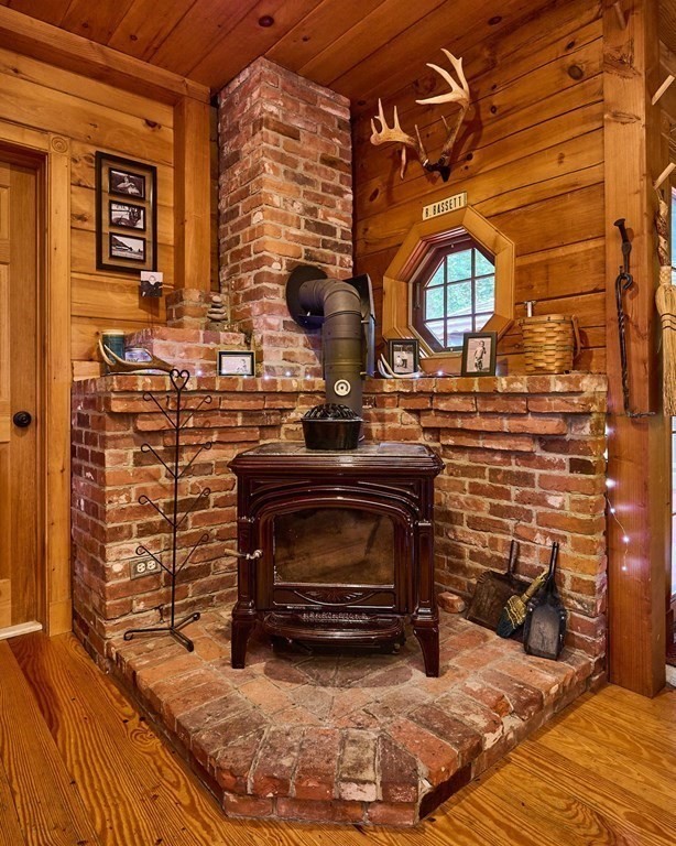 171 Tatro Road Ashfield, MA 01330 - Photo 20 of 42 a living room with fireplace furniture and a fireplace