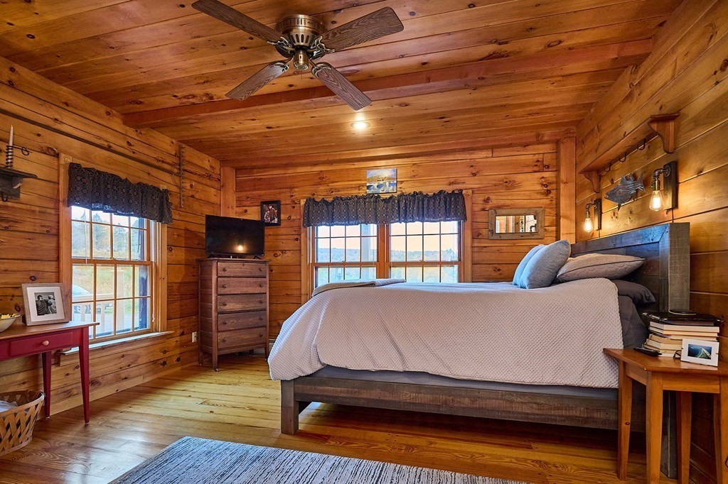 171 Tatro Road Ashfield, MA 01330 - Photo 21 of 42 a bedroom with a bed next to a window with a flat screen tv