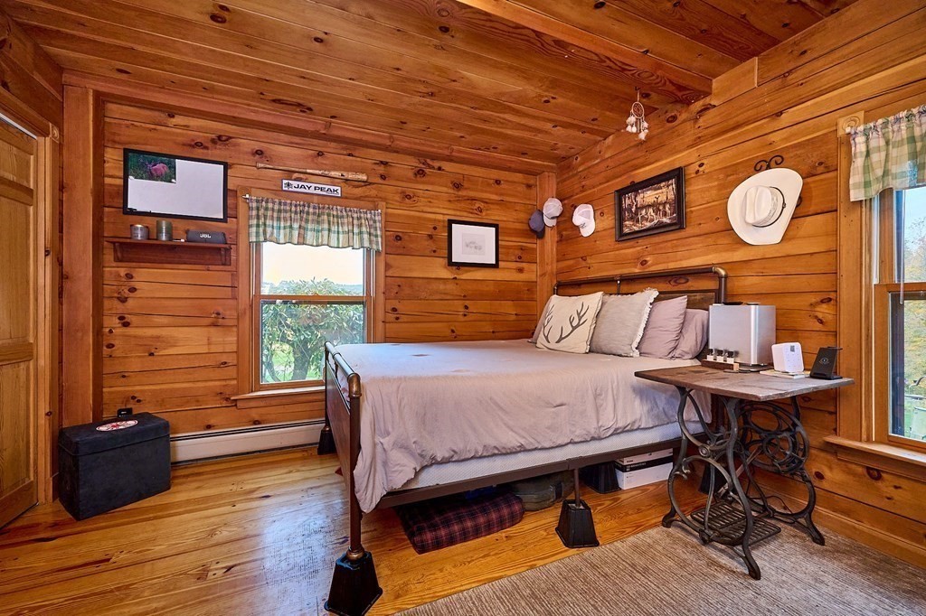 171 Tatro Road Ashfield, MA 01330 - Photo 25 of 42 a bedroom with a bed and wooden floor