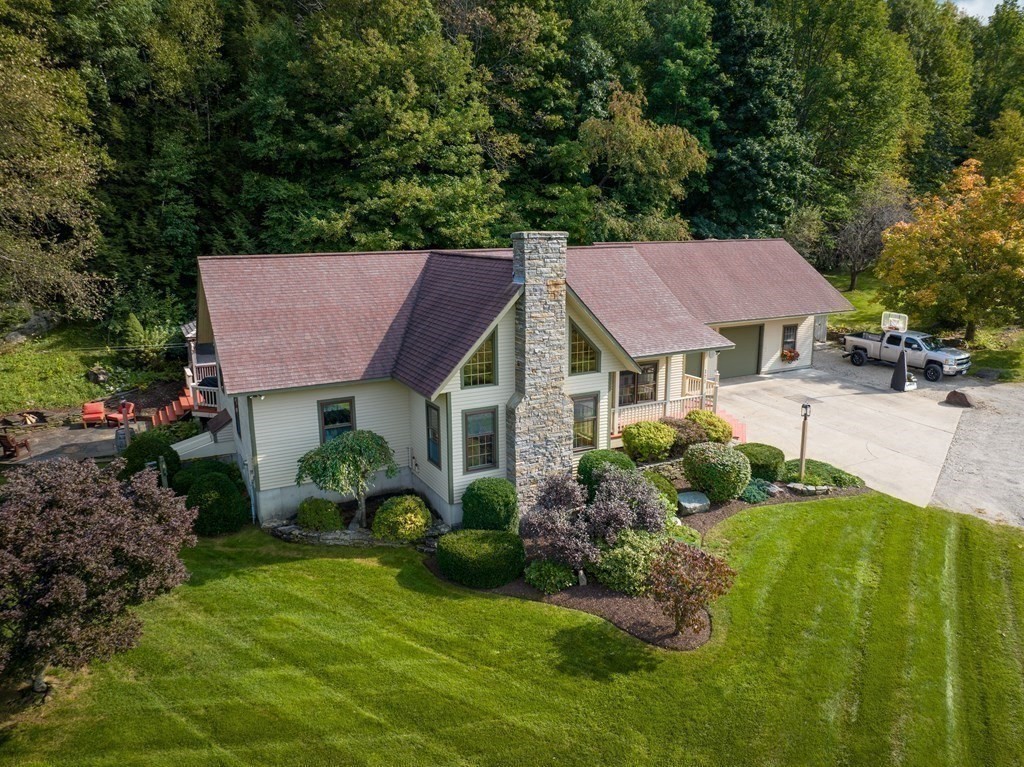 171 Tatro Road Ashfield, MA 01330 - Photo 40 of 42 a view of a house with a yard and plants