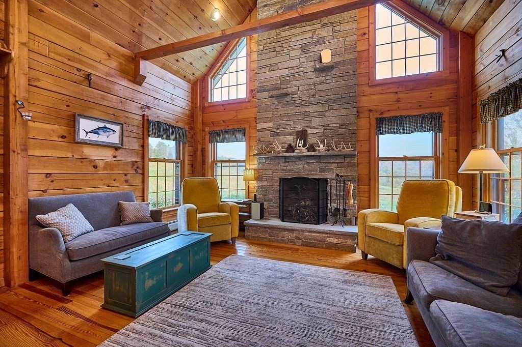 171 Tatro Road Ashfield, MA 01330 - Photo 10 of 42 a living room with furniture a fireplace and a large window
