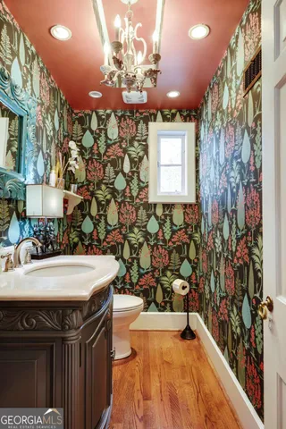 a view of a hallway with wooden floor and entryway