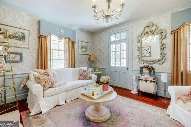 a view of a livingroom with furniture windows wooden floor and front door