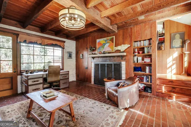 a bedroom with a large bed and wooden floor