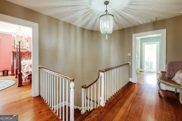 a spacious bathroom with a double vanity sink a mirror a bathtub and next to a window