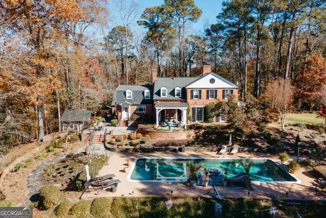 a view of swimming pool with a dining table and chairs
