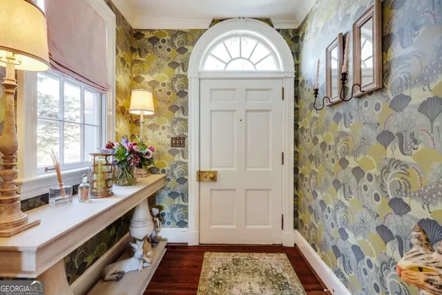 a living room with furniture a fireplace and a large window