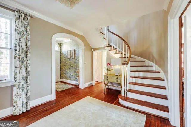 a view of a dining room with furniture wooden floor and chandelier