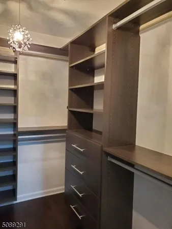 a view of walk in closet with empty racks