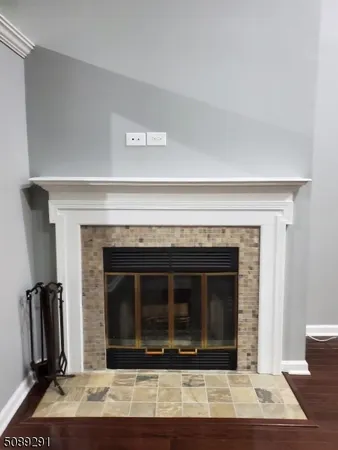 a living room with a fireplace and a rug