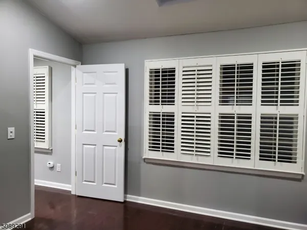 a view of wooden floor and a window