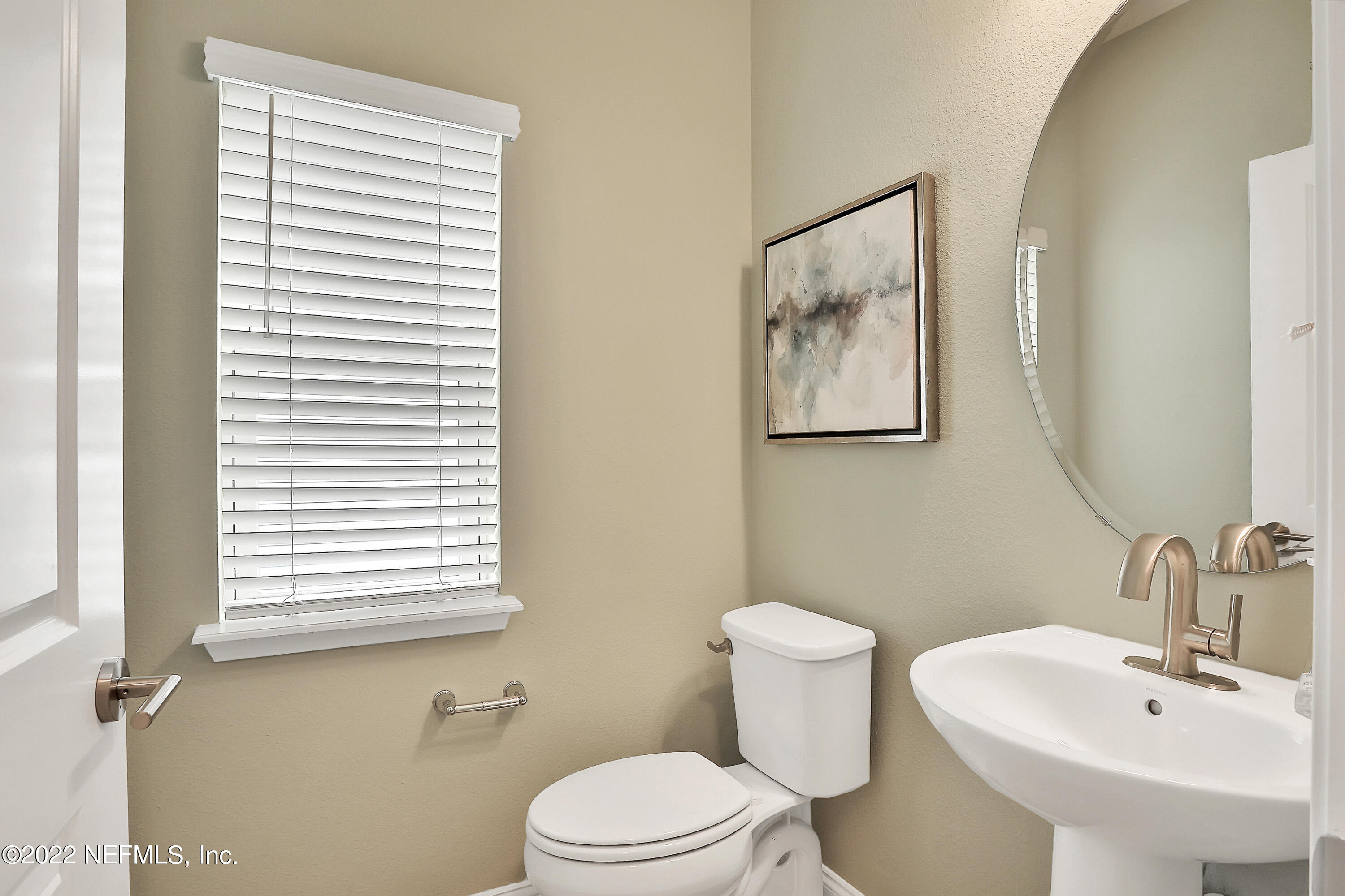 117 Crew Court St. Augustine, FL 32092 - Photo 7 of 64 a bathroom with a toilet a sink and a mirror