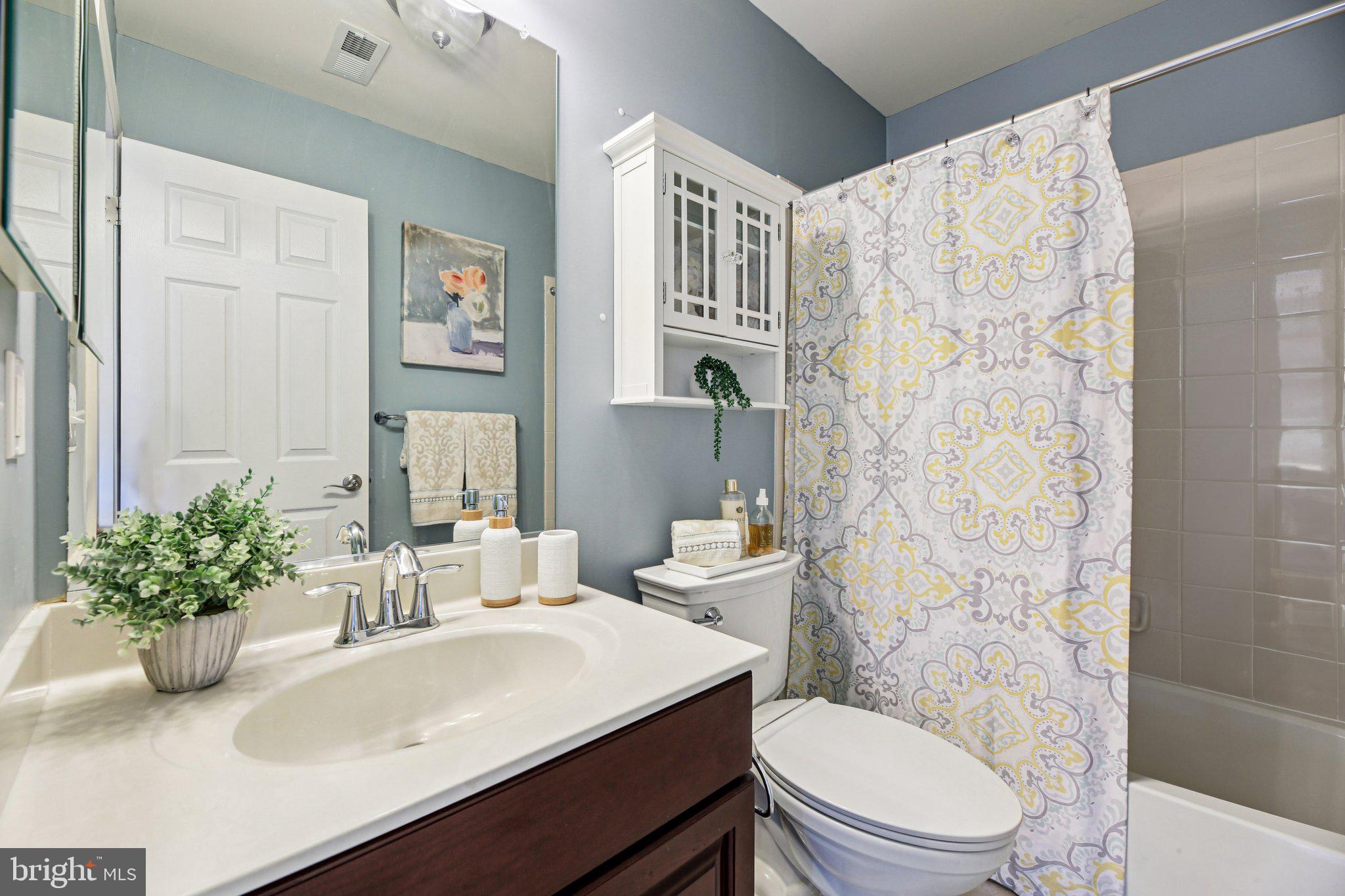 690 Tivoli Road Frederick, MD 21703 - Photo 27 of 43 a bathroom with a sink a toilet and shower curtain