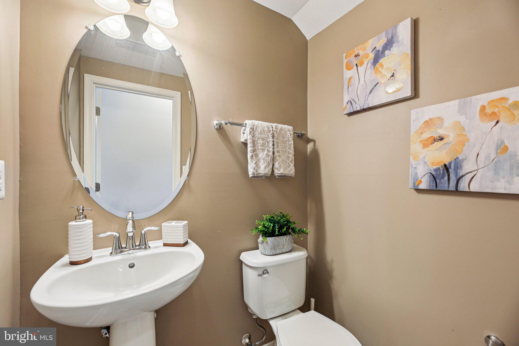 690 Tivoli Road Frederick, MD 21703 - Photo 34 of 43 a bathroom with a toilet a sink and a mirror