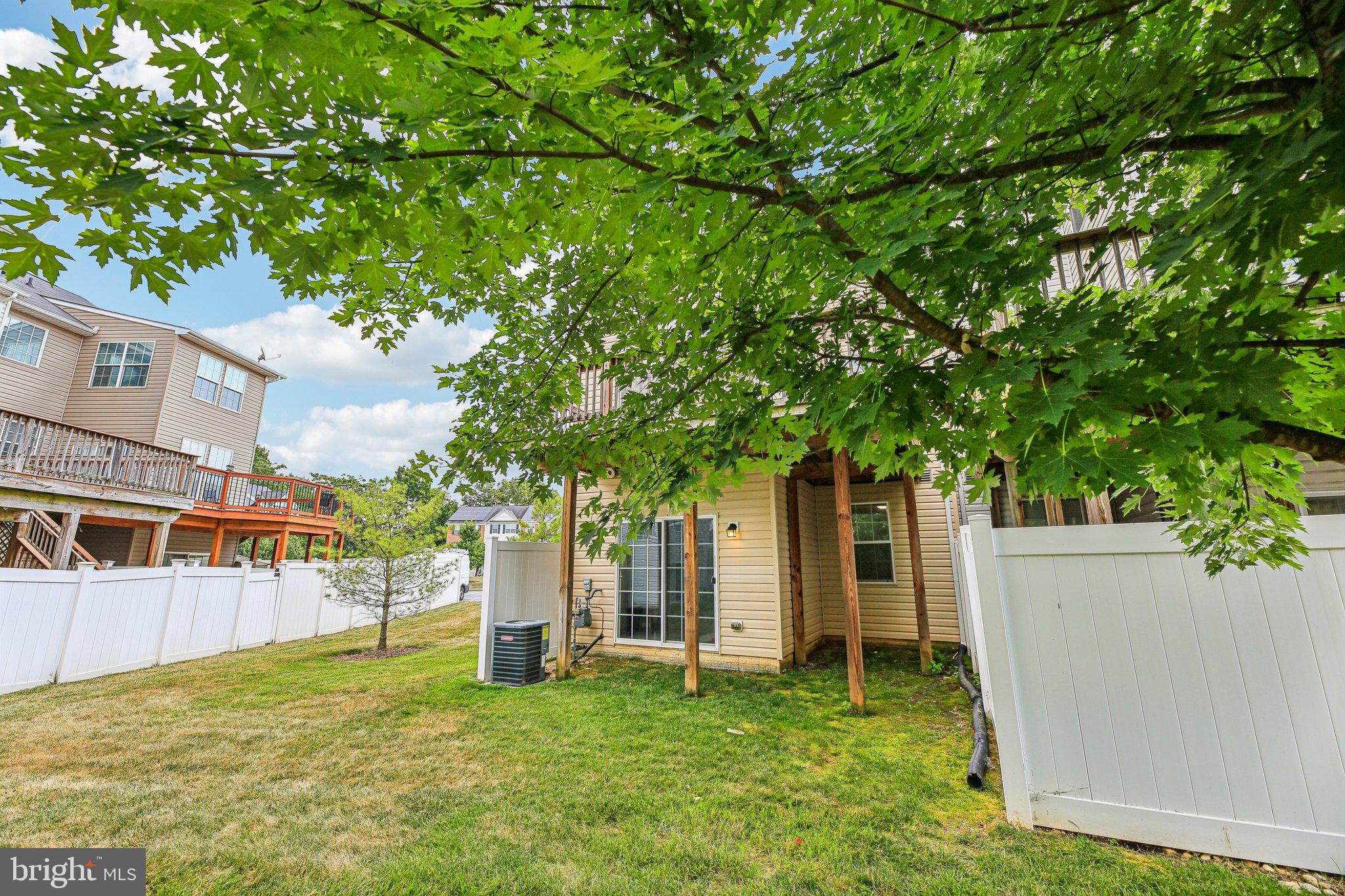 690 Tivoli Road Frederick, MD 21703 - Photo 37 of 43 a white house with a big yard and large trees