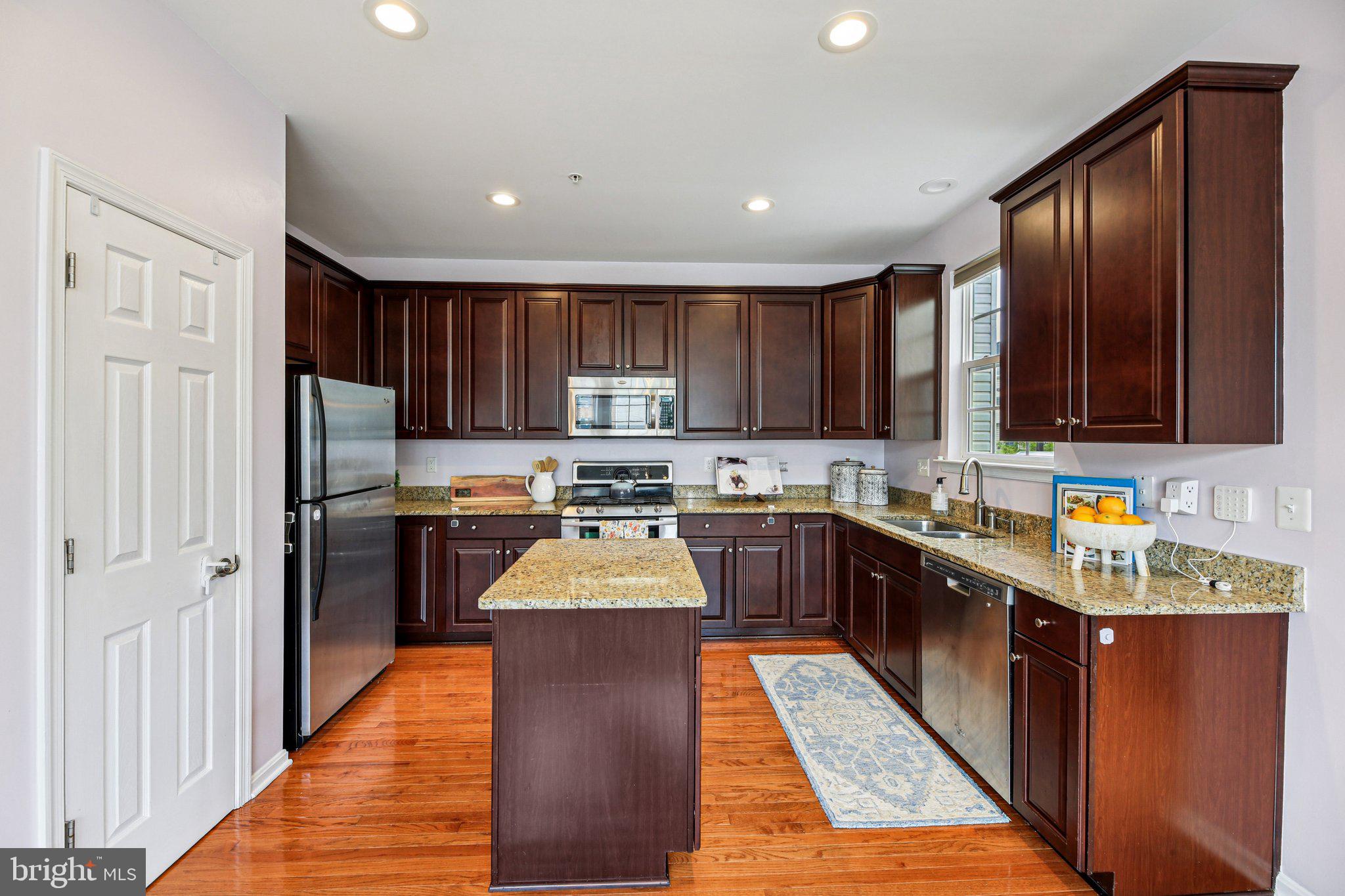 690 Tivoli Road Frederick, MD 21703 - Photo 9 of 43 a large kitchen with stainless steel appliances wooden cabinets a stove and a refrigerator
