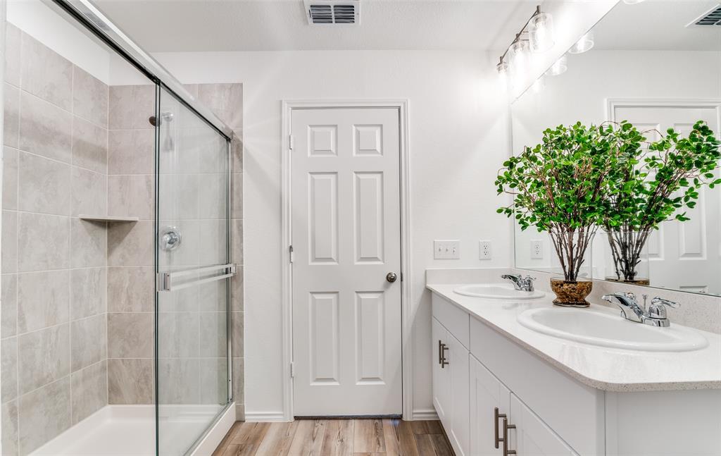 2109 Sugar Maple Lane Forney, TX 75126 - Photo 12 of 22 a bathroom with a sink a mirror and a shower