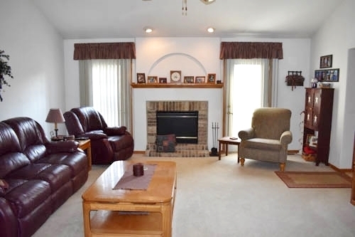 25109 Indian Ridge Road Sterling, IL 61081 - Photo 13 of 34 a living room with furniture and a fireplace