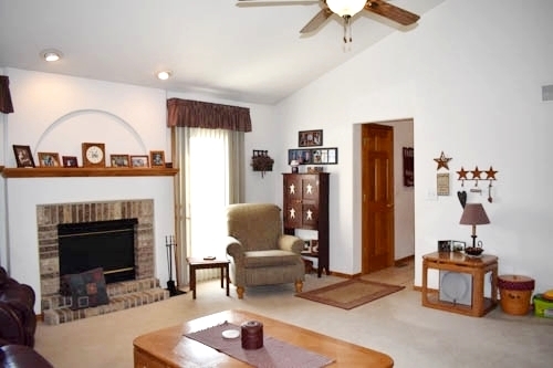 25109 Indian Ridge Road Sterling, IL 61081 - Photo 15 of 34 a living room with furniture and a fireplace